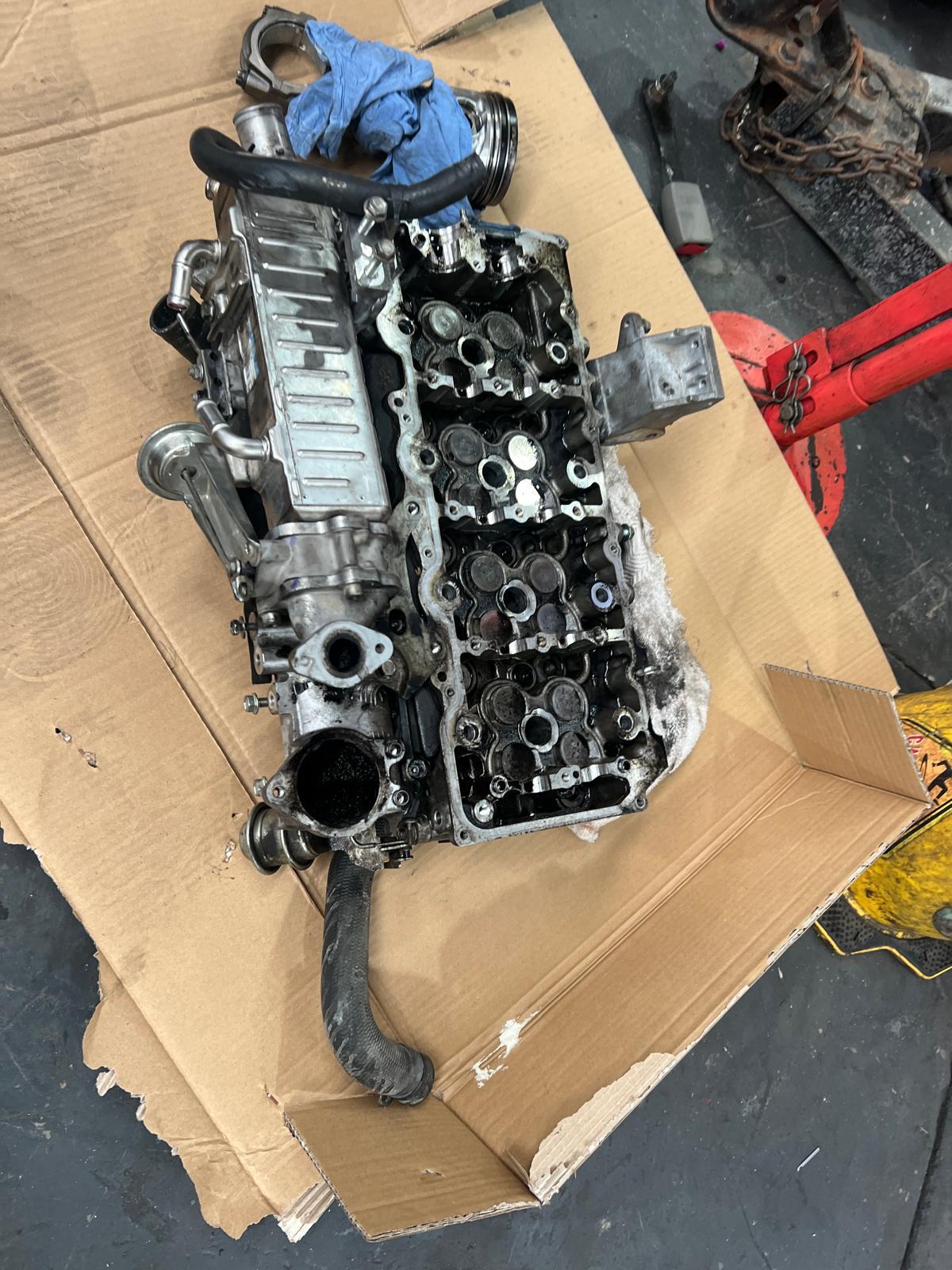 Diesel cylinder head removed for repair