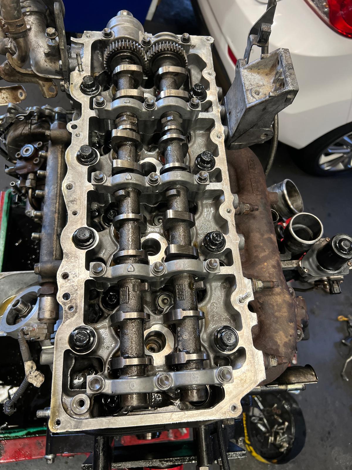 Cylinder head with camshafts exposed